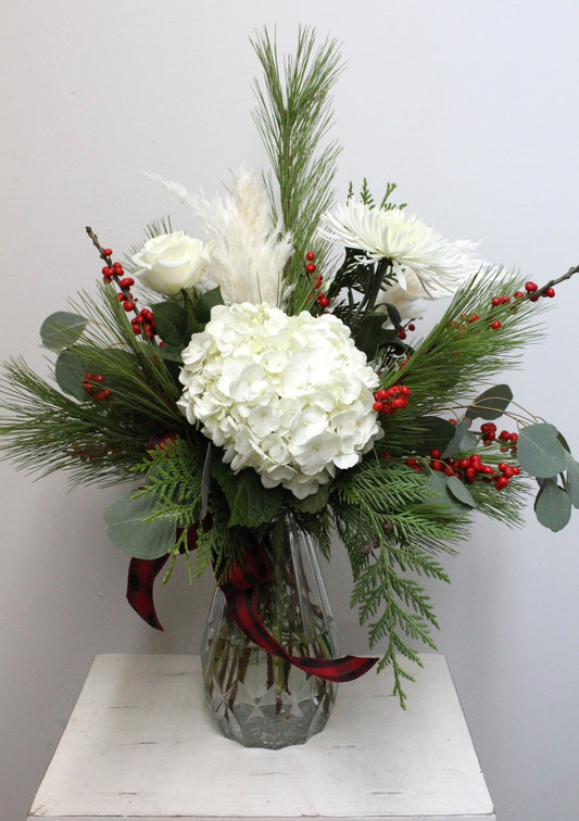 Bouquet de fleurs de Noël dans un vase au choix du fleuriste